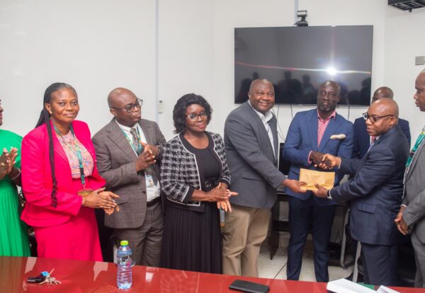Provost of the College of Health Sciences, Professor Christian Agyare (second right) presenting the cheques to KATH Medical Director, Kwadwo Sarbeng ((5th right) and Sammy Adu Boakye (4th right), Chairman of HekAP